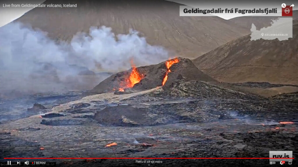 Two craters erupting. On the left side of the screen the crater there is showing splatter pattern while the one of the right side of the screen shows less spatter activity but small lava fall from the main eruption crater.