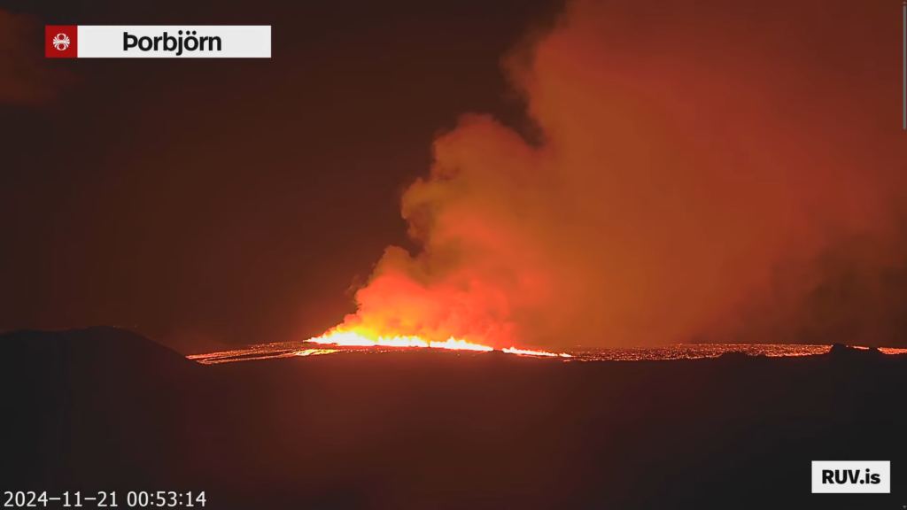 The eruption at 00:53 UTC. The lava fountains are lower and the gas cloud is smaller. Lava is seen flowing to the west from the eruption.