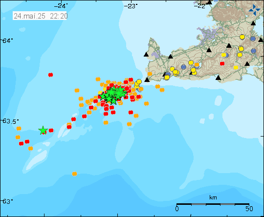 A lot of green stars and red dots on Reykjanes ridge out in the ocean. This shows the earthquake swarm just off the coast of Iceland.